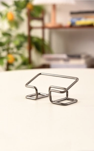 Macro shot of minimalist black wireframe business card holder with sleek metal finish