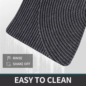 Detailed close-up showing dark grey PVC mat being rinsed with water for easy cleaning