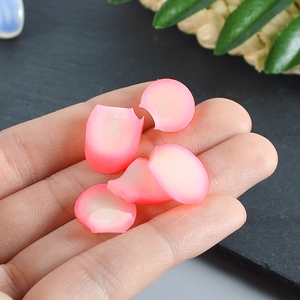 Miniature pink gradient resin flower petal model held in hand for scale and detail