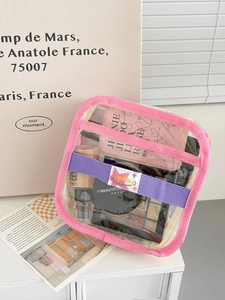 Detail of transparent PVC makeup bag with pink piping and purple interior elastic band