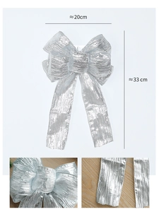 Silver Christmas bow detail showing shimmering crinkled fabric texture and 33cm size