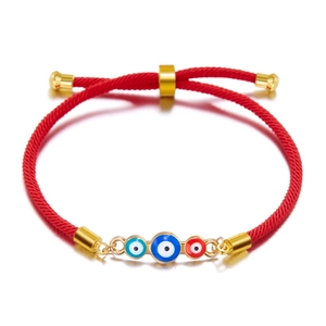 Adjustable red braided rope bracelet featuring three colorful evil eye beads in gold