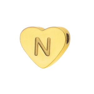 Close-up of heart-shaped gold letter N bead with mirror polish for DIY jewelry making