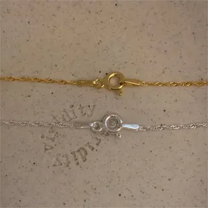 Macro detail of S925 sterling silver spring clasp with ITALY hallmark in gold and silver