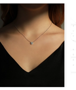 Gros plan d'un collier en argent avec pendentif moissanite sur le cou d'un mannequin