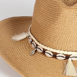 Men's and women's woven straw cowboy sun hat with shells and tassels for summer beach vacation