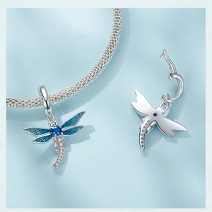 Macro view of S925 sterling silver dragonfly charm with blue enamel and crystal