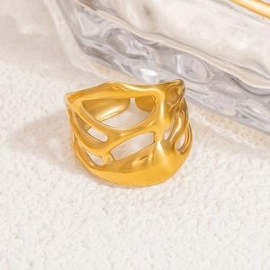 Close-up of golden wide镂空 ring with irregular fluid lines and metallic luster finish