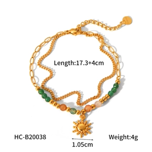 Detail view of double-layer gold sun charm bracelet with green beads and sizing data