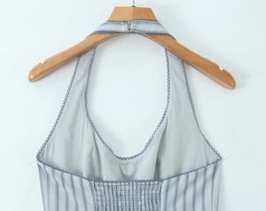 Detail of blue striped dress with navy ruffle straps and elastic waist on back