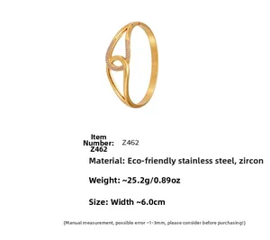 Detail of 18k gold plated stainless steel horseshoe bangle with pavé zirconia accents