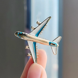 Fashionable cartoon airplane enamel brooch with pearl white body and blue wing details