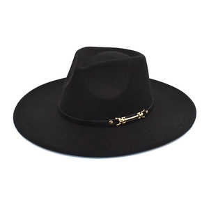 Detail of classic black wide brim felt hat with elegant gold metal buckle and trim