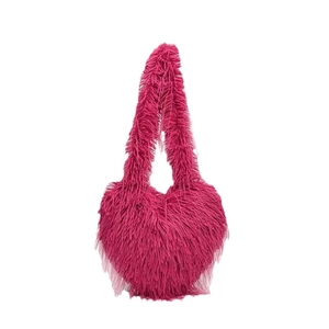 Plush heart-shaped faux fur handbag in vibrant rose red with long fluffy fringe texture