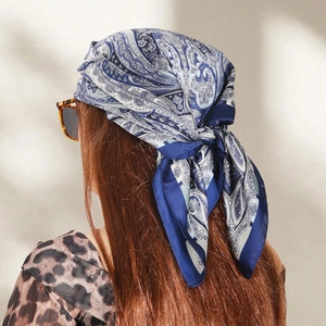 Blue and white paisley print silk scarf worn as a headscarf with vintage sunglasses