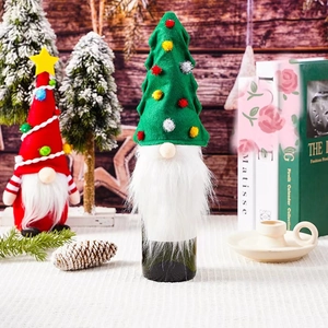 Close-up of festive Christmas tree and gnome wine bottle covers in a cozy setting