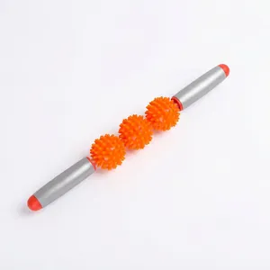 Detail of a manual muscle massage roller featuring three orange spiky balls and gray handles