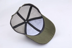 Detail view of the breathable mesh lining and camouflage fabric of the outdoor cap