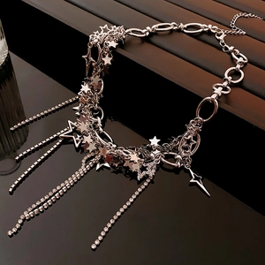 Close-up of silver star charms and sparkling rhinestone tassels on this Y2K fringe necklace