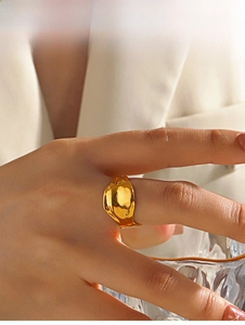 Detail of chunky gold organic lava ring with high-polished metallic mirror finish