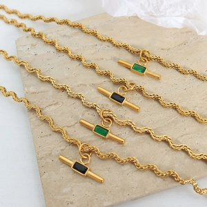 Golden wave chain necklace with rectangular green and black gemstones and T-bar toggle clasp