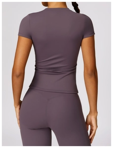 Detail view of the V-shaped back waistband on high-waist purple compression yoga leggings