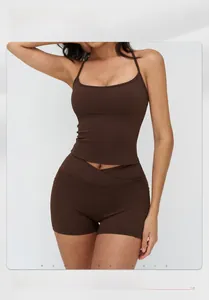 Brown high-stretch sports set featuring racerback top and cross-waist shorts on model