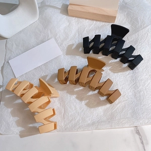 Three-piece set of large matte hair claw clips in black, brown and beige colors