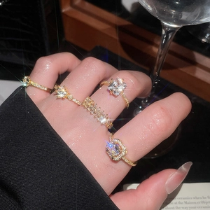 Close-up of 5pcs gold zircon ring set worn by model with sparkling gemstone details
