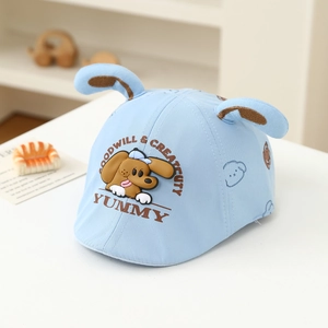 Detail view of light blue baby cap with 3D puppy ears and cartoon dog motif embroidery