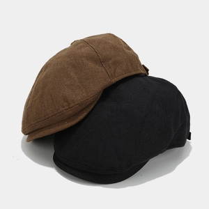 Detailed texture of retro linen newsboy caps in classic black and brown colors