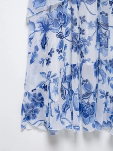 Detail of blue and white floral print chiffon dress with ruffle layers and soft fabric texture