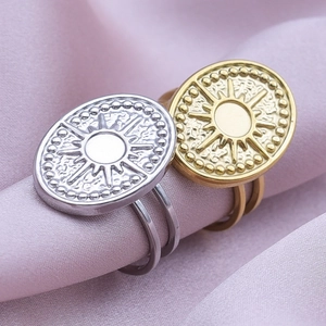 Macro detail of gold and silver sun totem rings with a dual-band vintage design