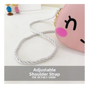 Detail of adjustable woven rope strap on pink cartoon rabbit crossbody bag for girls