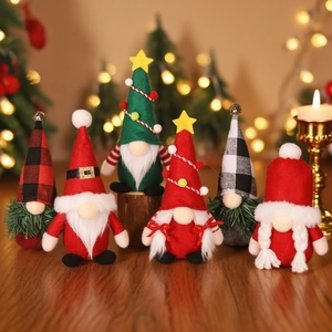 Set of six festive Christmas Gnomes with red and green hats on a wooden table