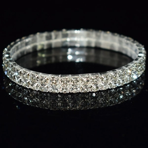 Macro shot of double-row rhinestone stretch bridal bracelet on black reflective background