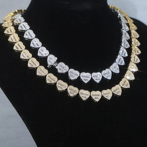 Detail of iced-out heart link necklaces with cubic zirconia in gold and silver finish