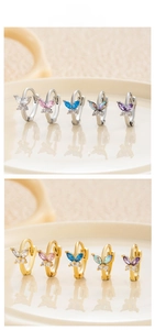 Detailed close-up of butterfly earrings with colorful cubic zirconia in gold and silver