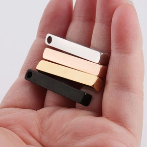 Detail of 3D bar pendants in silver, gold, rose gold and black finish on a palm