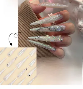 Detailed view of stiletto fake nails with 3D silver butterflies and pearl accents