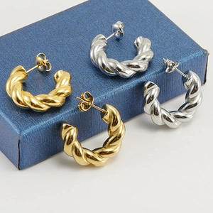 Twisted rope 18K gold and silver stainless steel hoop earrings in a jewelry box