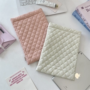 Detailed quilted rhombus texture on pink and beige padded laptop and tablet sleeves