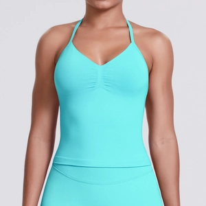 Close-up of bright cyan halter yoga bra featuring ruched center and high-stretch fabric