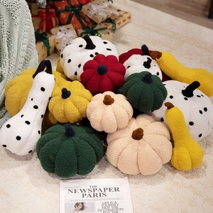 Plush pumpkin throw pillows in various colors and shapes for Halloween home decor