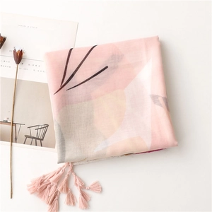 Detail shot of vintage floral cotton scarf with soft pink tassels and abstract print