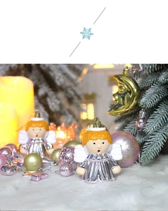 Close-up of gold and silver angel ornaments hanging on a decorated Christmas tree
