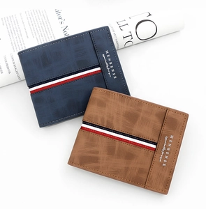 Close-up of dark blue and brown wallets with cross-pattern texture and stripe detail