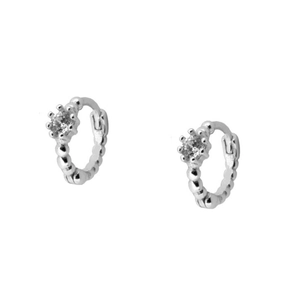 Detail of silver hoop earrings featuring sparkling cubic zirconia and beaded texture