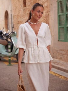 White cotton two-piece set with puff sleeve tie-front top and long skirt in street style