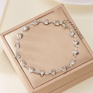 Sparkling silver heart link bracelet with clear crystals on a jewelry gift box